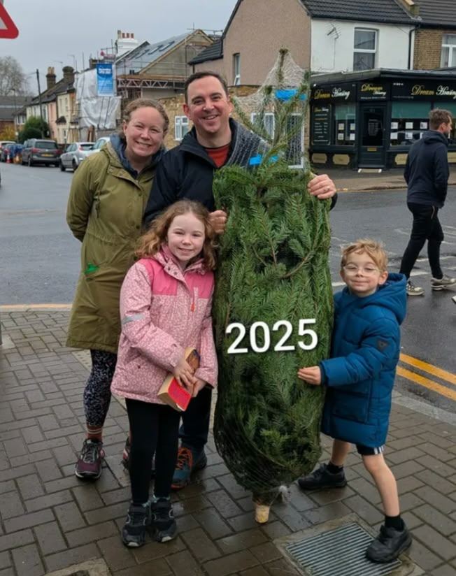 A family of four with their netted Christmas tree from our 2025 season