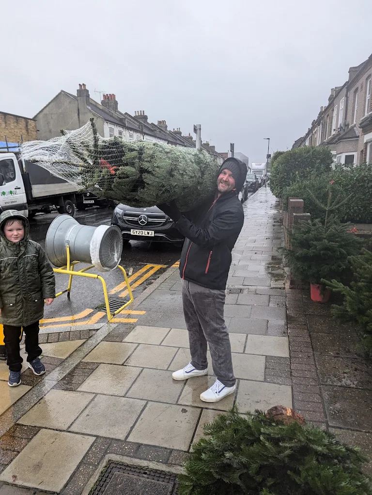 A dad and his son with their freshly netted Nordmann fir