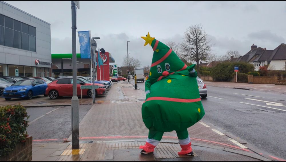 Our giant inflatable Christmas tree mascot on the pavement outside our stall